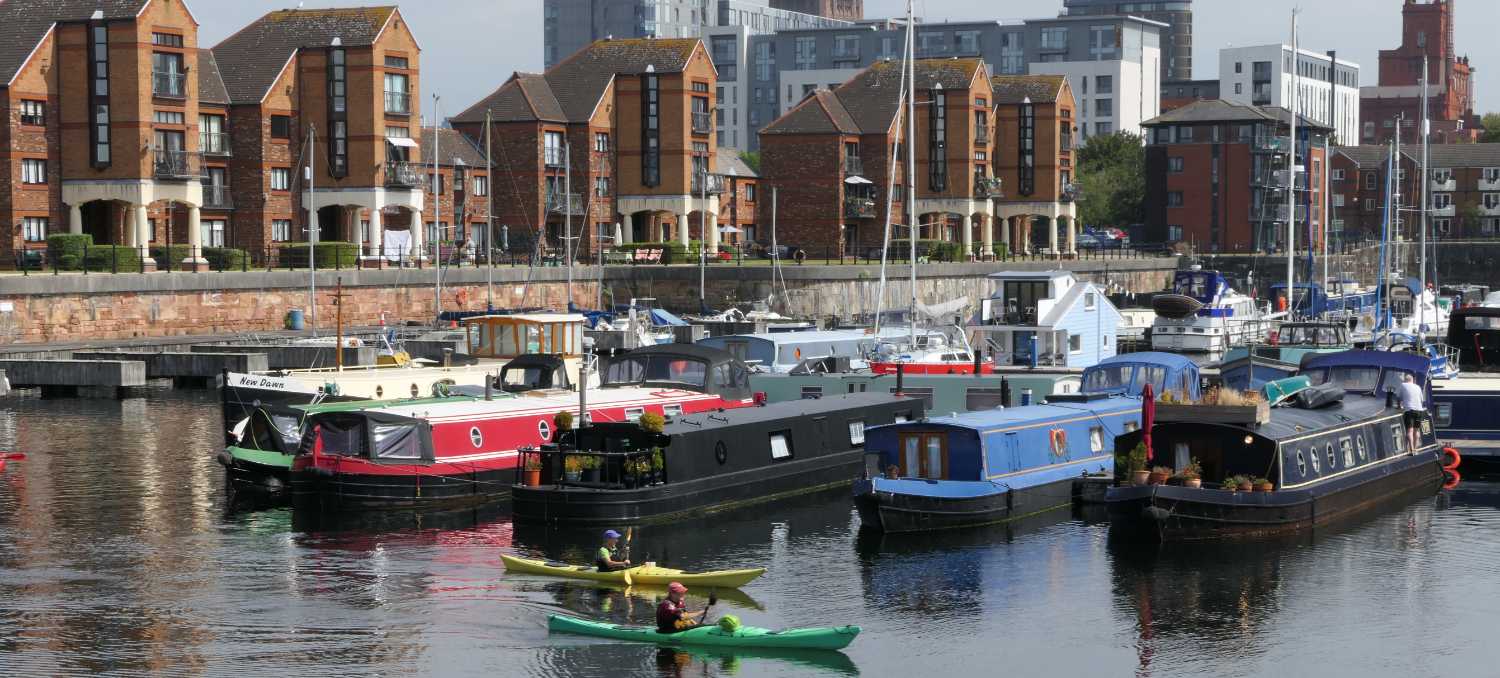 Canoes and narrow boats in the Brunswick Dock, one