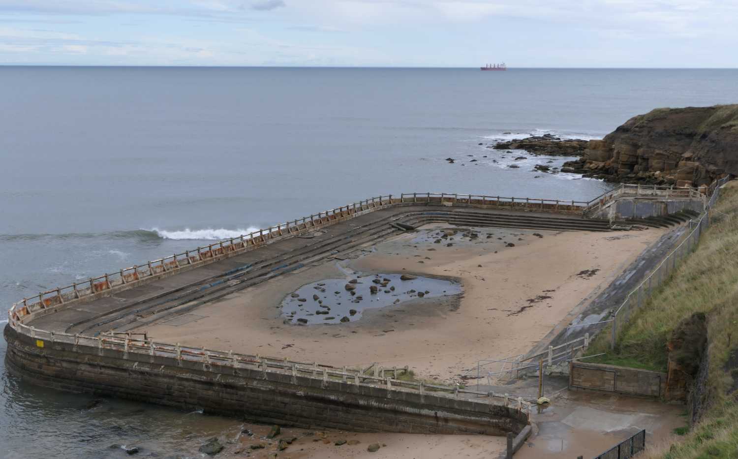 Tynemouth outdoor pool and tanker off the coast