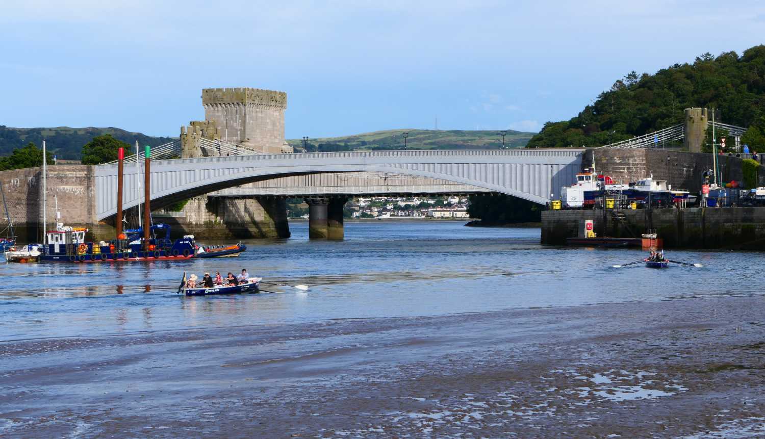 Two rowing boats approaching the old road bridge